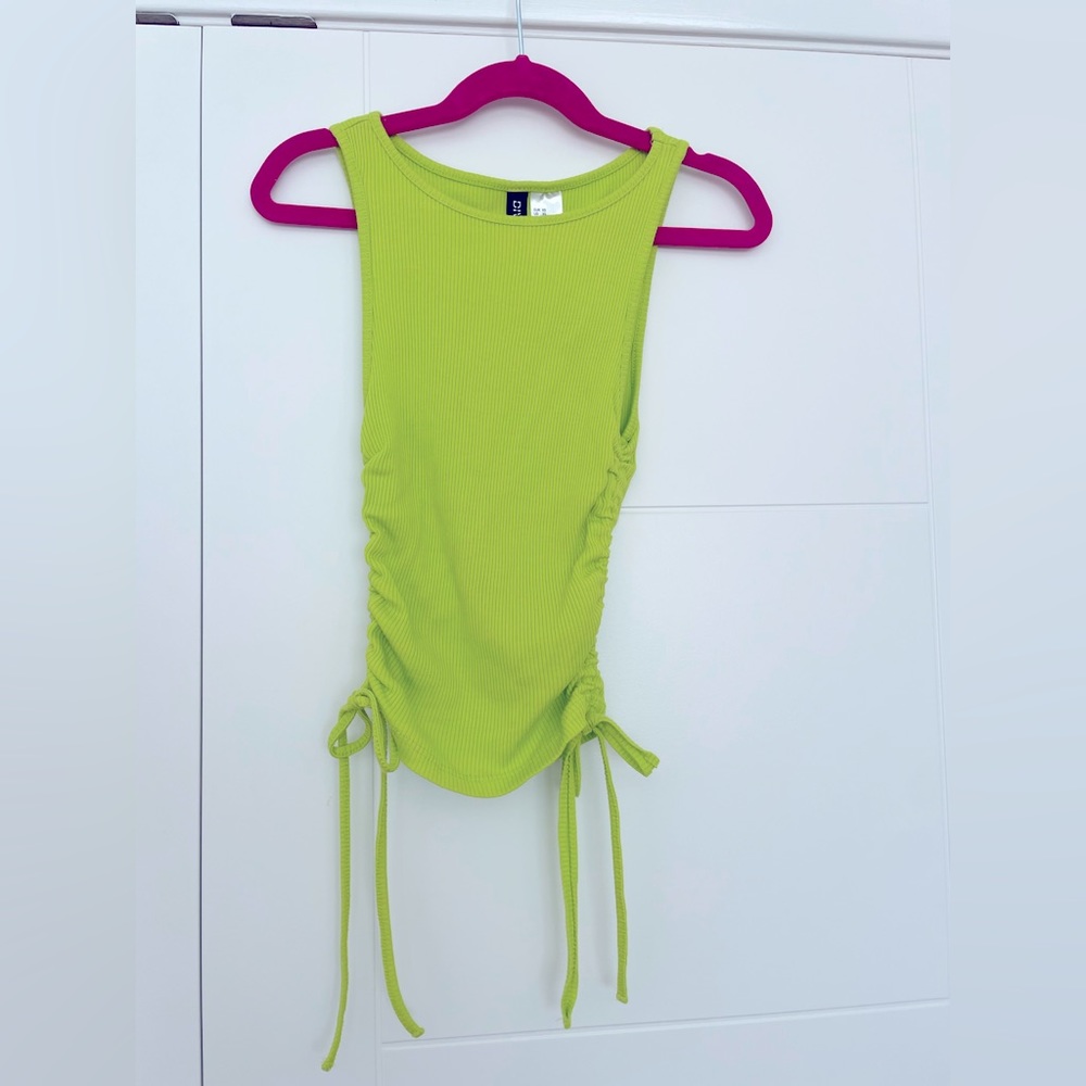 3/$15 Super cute top in bright green with side tie detail that can shorten top